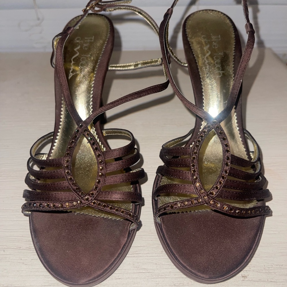 Brown heels with gold rhinestones.